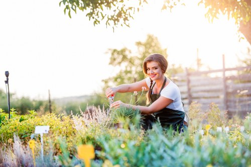 Crew member prepping tools in a garden, demonstrating insured gardening safety